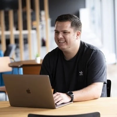 Jordan, the TaskAdoodles founder, working on the app at his laptop